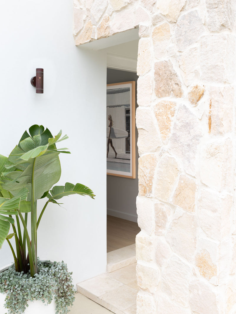 HAAUS.7 stone-clad entry column with view through to interior